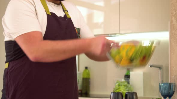 Man Mixing Vegetables in Salad Bowl