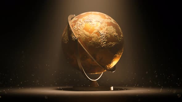 Golden globe trophy, award or spherical model of earth spinning in a light beam. alt