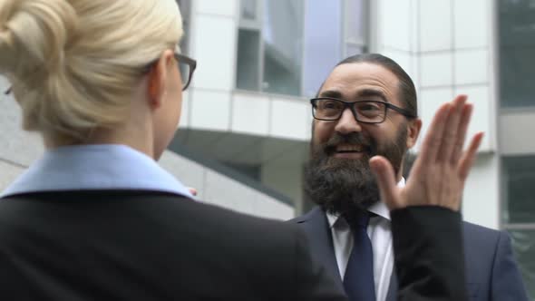 Handsome Middle Ages Businessman Giving High-Five to Lady, Successful Enterprise