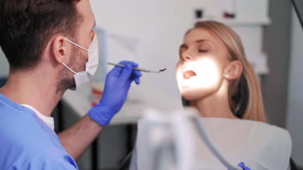 Dentist using dental drill and dental mirror alt