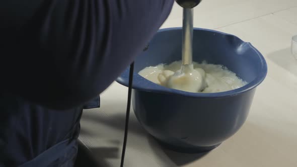 A Confectioner Uses an Immersion Blender to Pierce Hot Custard to Make Eclairs and Croissants