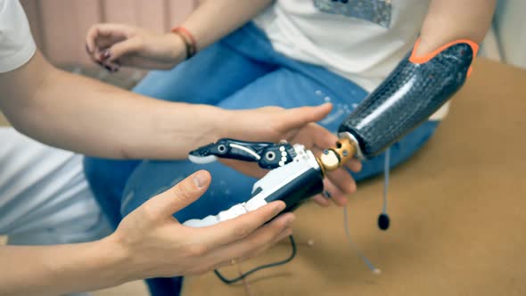 Robotic Limb, Prosthesis. Girl Use Bionic 3d Printed Arm for the First Time alt