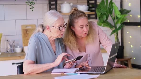 Woman Teaching Mother To Use Internet at Home alt