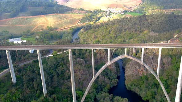 Aerial Flying Over New Ulla Viaduct With Old Gundian Bridge Behind It. Dolly Forward, Tilt Down alt