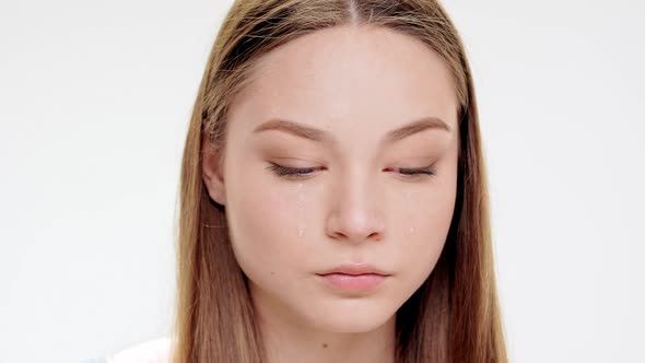 Sad Young Beautiful Girl Over Crying White Background alt