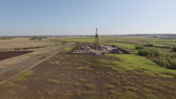 Aerial Shot of Petroleum Reservoir in Field with Large Oil Well