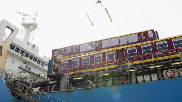 Crane Lowering Train Carriage Car From Bulk Cargo Vessel