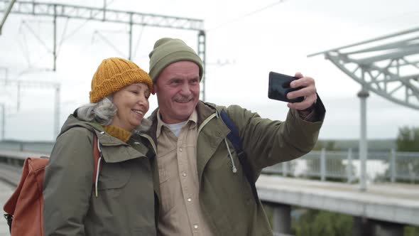 Senior Couple Making Selfie on Train Station alt