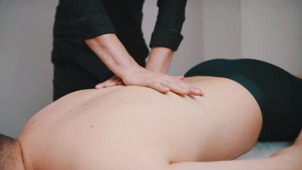 Chiropractic or Physiotherapist Giving Back Massage To Patient, Close Up Slow Motion Shot alt
