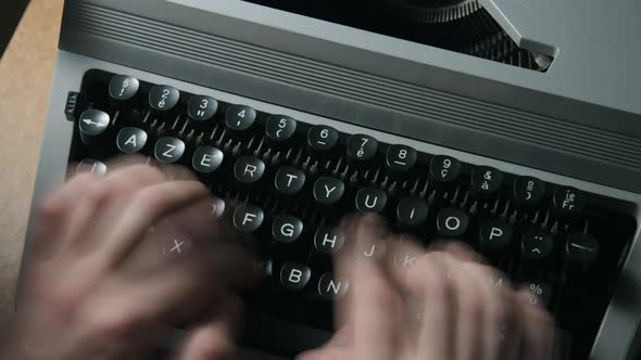 A man typing on a typewriter