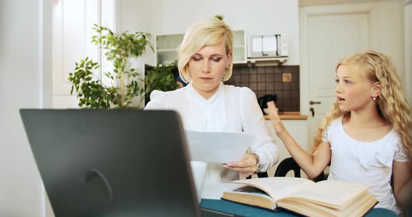 Mother Working on Laptop Ignoring Girl