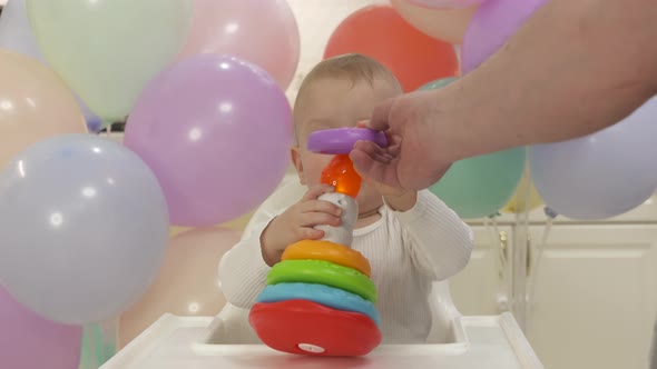 Cute Small Child Playing with Pyramid Toy One Year Old Kid Stacking the Rings on the Cone