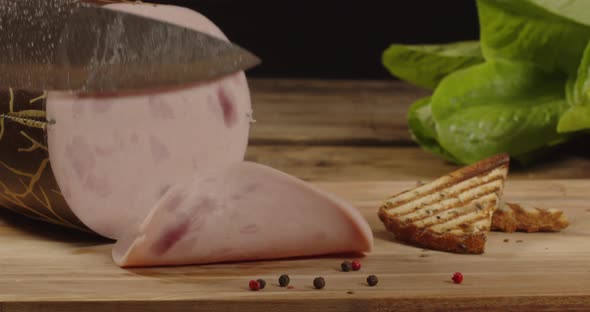 With A Knife Cut Off A Thin Slice Of Sausage alt