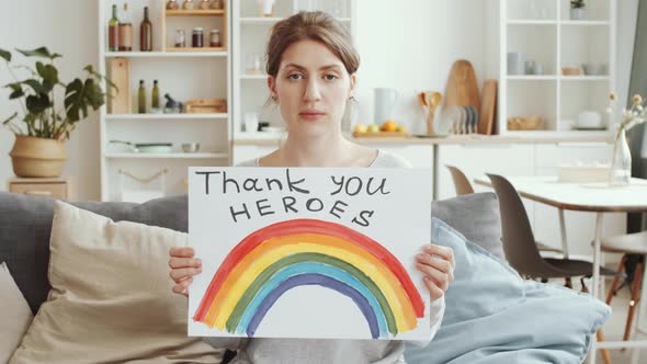 Woman Posing with Poster with «NHS thank you heroes» Sign and Rainbow alt