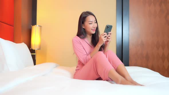 Young asian woman use smart phone alt