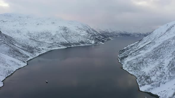 Fjord surrounded with mountains covered with snow, Tromso, Norway