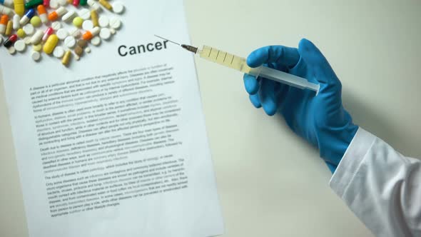 Cancer Word Written Conclusion, Hand Holding Medication in Syringe, Medication alt