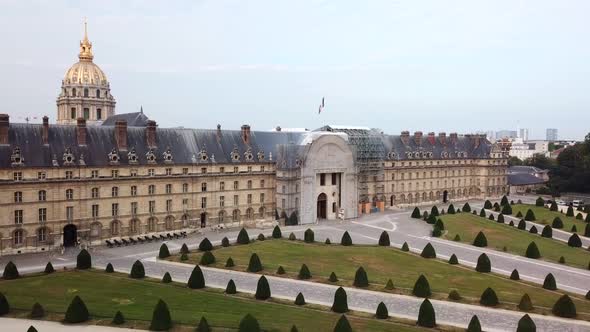 Vertical drone elevation facing square with small shape-cut trees and historical building of Hotel d alt