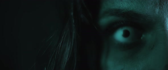 Terrifying creepy zombie woman, close up of white eye opening. Scary look. alt