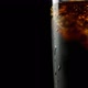 Glass With Whiskey And Soda With Ice Cubes And Bubbles On A Black Background - VideoHive Item for Sale