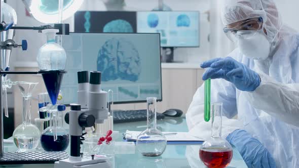 Slowly Zooming in Shot of Researcher in Modern Laboratory Taking Samples From Tubes alt