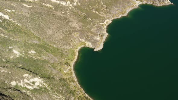 Bird eyes perspective of the edge of the Quilotoa lake a lake from an inactive vulcano in Ecuador alt