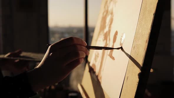 Close Up Slow Motion Footage of a Gifted Female Artist Drawing with Paint Brush on Cancas on Easel alt