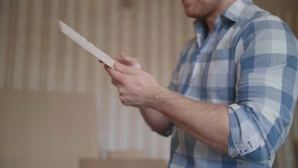 Carpenter Chooses Material for Harvesting