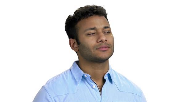 Pensive Indian Guy Smiling on White Background alt
