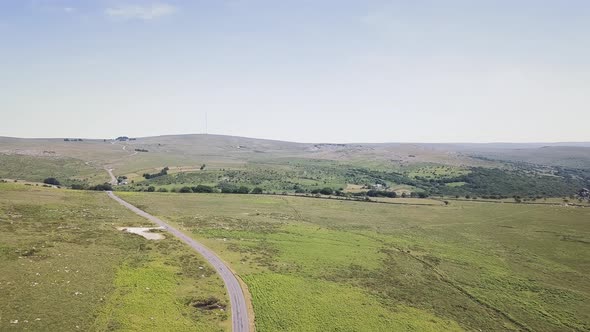 Panorama view of Dartmoor national park. Road cutting through English national park. alt