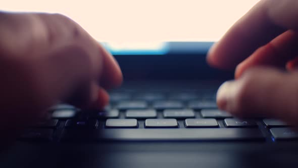 Freelancer working at home on notebook computer, video filmed in 4K alt