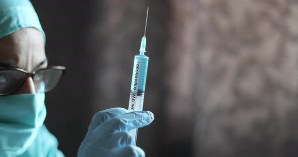 Doctor holding a syringe with the coronavirus COVID-19 vaccine