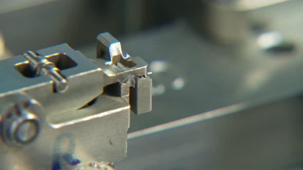 Advanced industrial production line for small parts, robotic arms working alt