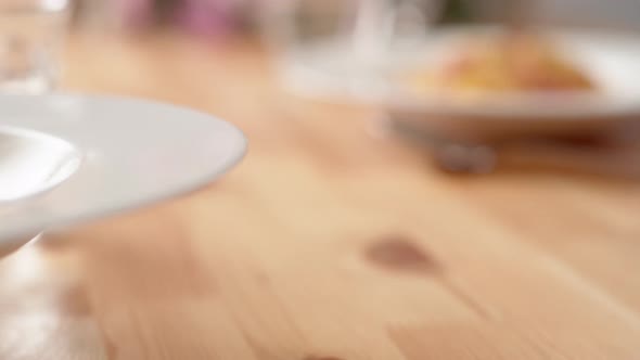 Camera follows carbonara pasta being served on table.  Slow Motion. alt