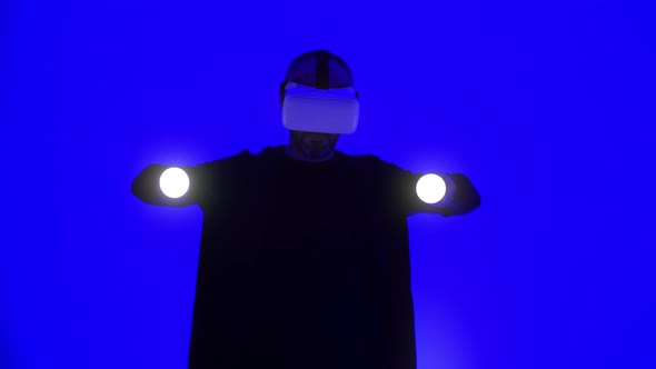 Professional Male Coder Wearing Augmented Reality Glasses Makes Gestures alt