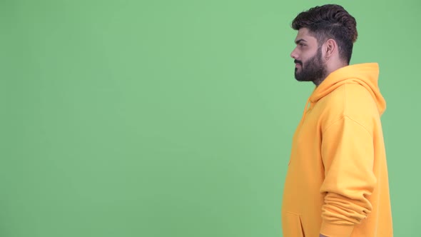 Profile View of Happy Young Overweight Bearded Indian Man Smiling alt