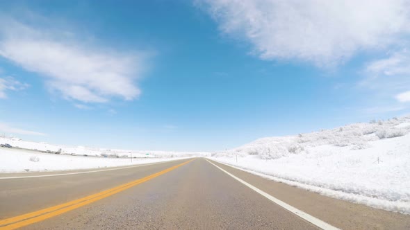 Driving on suburban road after Spring snow storm. alt