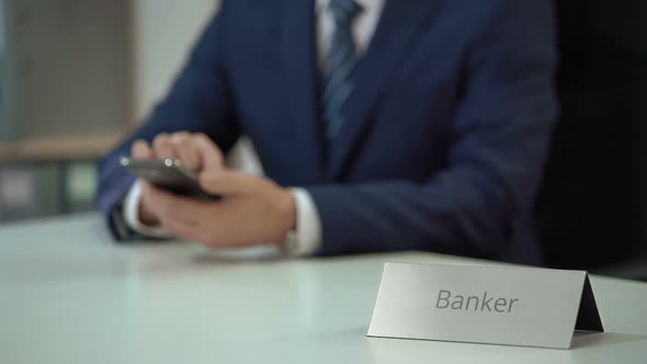 Male Banker Typing Message on Smartphone, Scrolling and Zooming Pages on Screen alt