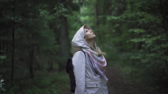 Traveler Girl Standing And Looking Around In Dark Forest