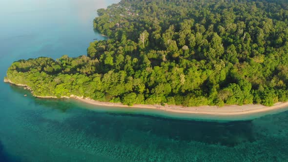 Aerial: flying over tropical Ai island white sand beach Banda Islands Indonesia alt