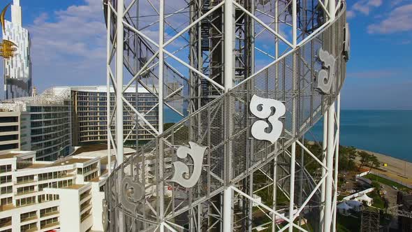 Alphabetic Tower with Crystal Ball on Top Against Calm Blue Sea, Batumi Georgia alt