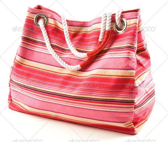 Pinkish canvas striped beach bag with rope shoulder strap - Stock Photo - Images