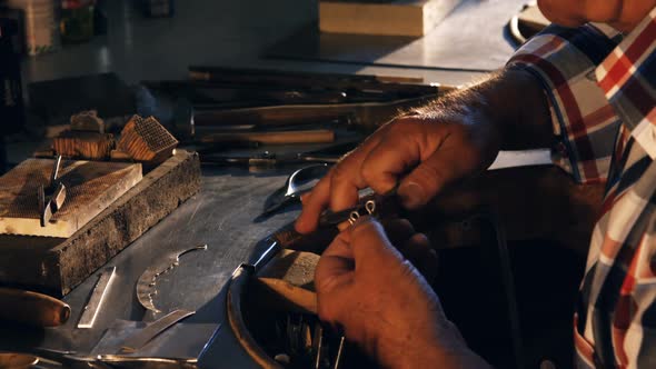Goldsmith working in workshop alt