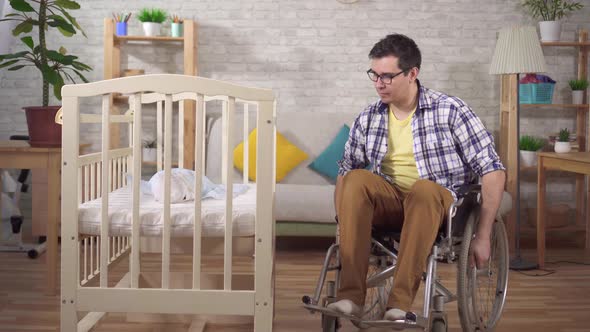 Disabled Man in a Wheelchair a Young Father in a Children's Bedroom alt
