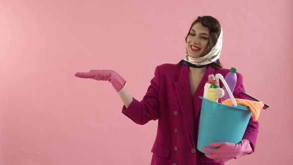 A Woman Holds a Bucket of Cleaning Tools