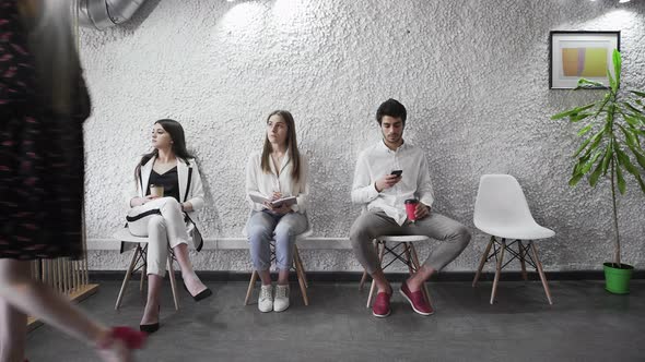 Diverse Candidates for Vacancy Sitting on Chairs Waiting Their Turn alt