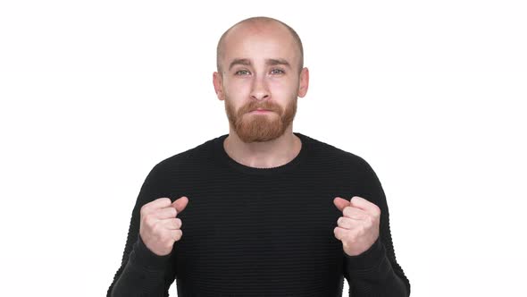 Portrait of Young Man Being Ecstatic About Reaching Goals Clenching Fists in Pleasure Like Winner or alt