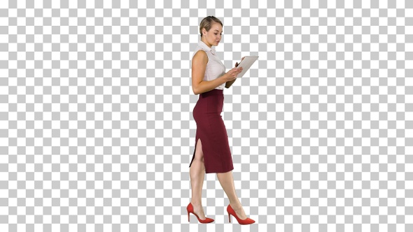 Businesswoman using electronic tab walking, Alpha Channel alt