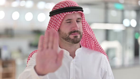 Serious Arab Businessman Showing Stop Sign By Hand alt