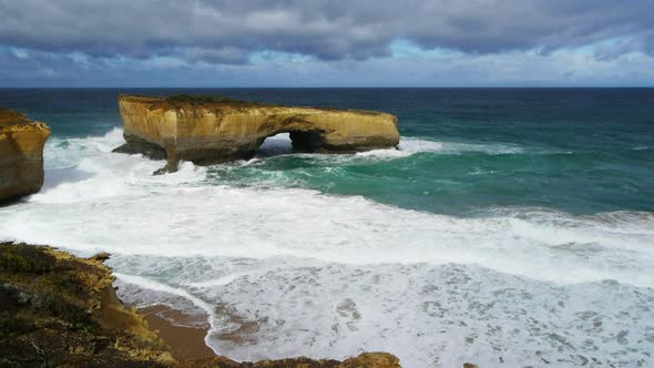 wide shot of the limestone formation known as london bridge on the great ocean road alt